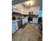Kitchen featuring white cabinetry, modern appliances and tiled floors at 1771 Bayview Dr, Lakeland, FL 33805