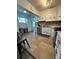 A cozy kitchen featuring granite countertops, tile backsplash, and modern appliances at 1771 Bayview Dr, Lakeland, FL 33805