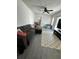 Cozy living room with a plush sofa and neutral-toned rug and hardwood floors at 1771 Bayview Dr, Lakeland, FL 33805