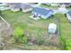 Aerial view showcases a spacious backyard with a patio, shed, and play equipment, all within a fenced perimeter at 1784 Williamsburg Dr, Bartow, FL 33830