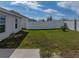 View of the fenced yard showing the edge of the home and the side yard at 1946 Pond Pine Ct, Haines City, FL 33844