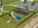 Aerial view of the community playground with modern equipment and shade structure at 1946 Pond Pine Ct, Haines City, FL 33844