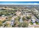 Beautiful aerial view of a residential neighborhood surrounded by lush trees and scenic lake views at 21 Townhill Dr, Eustis, FL 32726