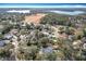 Panoramic aerial view of a residential neighborhood near a tranquil lake and open land, ideal for families at 21 Townhill Dr, Eustis, FL 32726