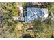 An aerial view shows the home's roof, driveway, yard, and outdoor living space with landscaping at 21 Townhill Dr, Eustis, FL 32726