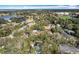 This aerial view highlights a residential area with tree-lined streets, a community lake, and recreational fields at 21 Townhill Dr, Eustis, FL 32726
