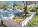 A lush backyard with a privacy fence, large trees, and screened lanai adds charm to this property at 21 Townhill Dr, Eustis, FL 32726