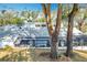 The enclosed lanai is featured in this aerial view with mature trees that accentuate the backyard at 21 Townhill Dr, Eustis, FL 32726