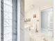 Bright bathroom with privacy glass block accents, a stylish vanity, and marble patterned tile floor at 21 Townhill Dr, Eustis, FL 32726