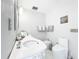 A clean, well-lit bathroom with white cabinets, a bidet, and marble tiled floors at 21 Townhill Dr, Eustis, FL 32726