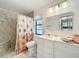 Bathroom featuring marble tile, updated vanity, and shower at 21 Townhill Dr, Eustis, FL 32726