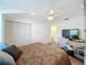 Bright bedroom with a ceiling fan, closet, and natural light at 21 Townhill Dr, Eustis, FL 32726