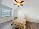 Airy bedroom with a ceiling fan, lots of light, and wooden-look vinyl flooring at 21 Townhill Dr, Eustis, FL 32726