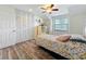 Charming bedroom with a large closet and wood-look floors at 21 Townhill Dr, Eustis, FL 32726