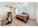 Cozy bedroom featuring wood floors, a ceiling fan, and built-in storage at 21 Townhill Dr, Eustis, FL 32726
