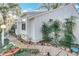 The side of the house features charming landscaping, hardscape, and white privacy fence at 21 Townhill Dr, Eustis, FL 32726