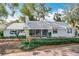 Charming single-story home with a manicured lawn, white picket fence, and inviting front porch at 21 Townhill Dr, Eustis, FL 32726