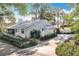 A single-story home featuring a well-kept lawn, driveway, and white fence, offering a welcoming ambiance at 21 Townhill Dr, Eustis, FL 32726