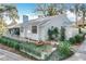 Charming one-story home with white exterior, manicured lawn, and lush landscaping at 21 Townhill Dr, Eustis, FL 32726