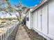 Exterior side view of the house with mature trees, sidewalk and lush landscaping at 21 Townhill Dr, Eustis, FL 32726