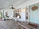Inviting front porch featuring tiled flooring, wicker furniture, and a decorative wreath on the door at 21 Townhill Dr, Eustis, FL 32726