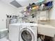 Functional laundry room equipped with modern washer, dryer, and ample storage at 21 Townhill Dr, Eustis, FL 32726