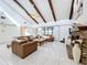 Inviting living room with vaulted ceilings, exposed wood beams, fireplace, and tile flooring at 21 Townhill Dr, Eustis, FL 32726