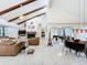 Open-concept living room with vaulted ceilings, exposed wood beams, and a decorative fireplace at 21 Townhill Dr, Eustis, FL 32726