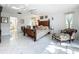 Bright main bedroom with tile floors, a ceiling fan, and comfortable seating, creating a relaxing ambiance at 21 Townhill Dr, Eustis, FL 32726