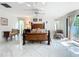 Spacious main bedroom with tile floors, a ceiling fan, and comfortable seating, offering relaxation at 21 Townhill Dr, Eustis, FL 32726