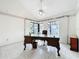 Bright home office featuring tile floors, a ceiling fan, and abundant natural light from large windows at 21 Townhill Dr, Eustis, FL 32726