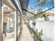 Beautifully landscaped patio with tiled flooring, plants, and a bright seating area at 21 Townhill Dr, Eustis, FL 32726