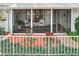 Cozy screened porch features comfortable seating and views of the lush landscaping at 21 Townhill Dr, Eustis, FL 32726