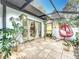 Relaxing sunroom features tiled floors, hanging plants, and a comfy hanging chair at 21 Townhill Dr, Eustis, FL 32726
