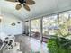 Bright sunroom with large windows offering serene views, tiled floor, and comfortable seating at 21 Townhill Dr, Eustis, FL 32726