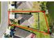 An aerial view of a property with a well-maintained lawn, privacy fence, and proximity to a tranquil lake at 2443 Torrens Dr, Lakeland, FL 33805
