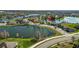 Scenic aerial view of the home nestled by a serene lake in a residential neighborhood at 2443 Torrens Dr, Lakeland, FL 33805