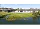 Back of the house with fenced in backyard, screened-in lanai, and access to a pond at 2443 Torrens Dr, Lakeland, FL 33805