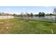 A spacious green backyard enclosed by a fence with a lake view at 2443 Torrens Dr, Lakeland, FL 33805