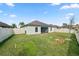 Backyard featuring a green lawn and a white fence at 2443 Torrens Dr, Lakeland, FL 33805