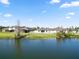 Lush backyard leading to a serene lake, enhanced by well-maintained landscaping at 2443 Torrens Dr, Lakeland, FL 33805