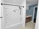 Bathroom showcasing a tub/shower combo with black fixtures and a vanity with modern lighting at 2443 Torrens Dr, Lakeland, FL 33805