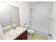 Standard bathroom featuring a shower-tub combo, toilet, and vanity sink at 2443 Torrens Dr, Lakeland, FL 33805