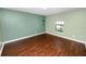 This bedroom features wood floors and a window for natural light at 2443 Torrens Dr, Lakeland, FL 33805