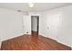 Spacious bedroom with wood-look floors and multiple entryways at 2443 Torrens Dr, Lakeland, FL 33805