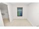 A sunlit bedroom with ceramic tile flooring, a window and a door to a walk-in closet at 2443 Torrens Dr, Lakeland, FL 33805