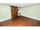 Bedroom featuring wood-look floors and a rustic sliding barn door at 2443 Torrens Dr, Lakeland, FL 33805