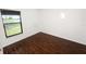 An empty bedroom featuring wood-look flooring and a window with wooden blinds at 2443 Torrens Dr, Lakeland, FL 33805