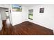 Bedroom features wood-look flooring, natural light, and a wall-mounted TV for entertainment at 2443 Torrens Dr, Lakeland, FL 33805