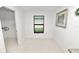 This dining area has bright, white tile flooring and a window overlooking the exterior at 2443 Torrens Dr, Lakeland, FL 33805